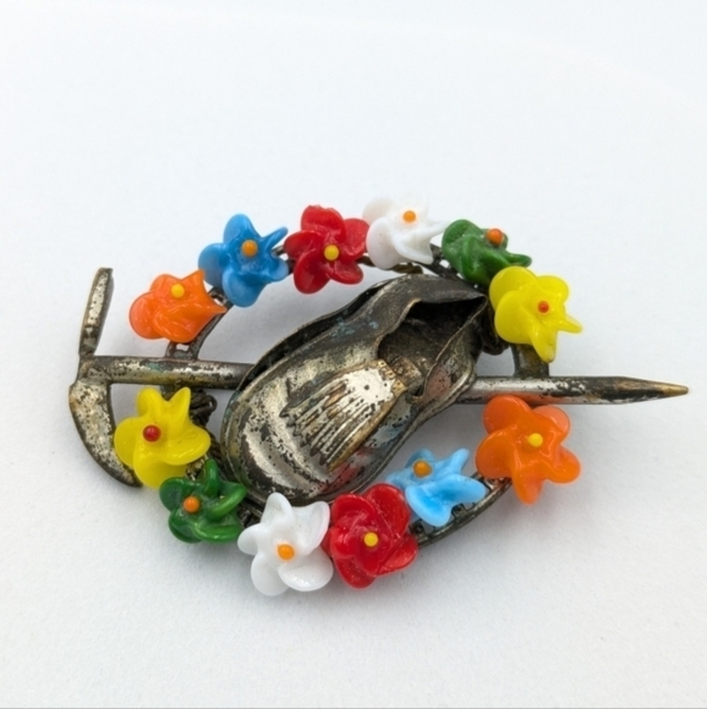 Antique alpine flowers (bakelite?), shoe, and ice pick brooch pin